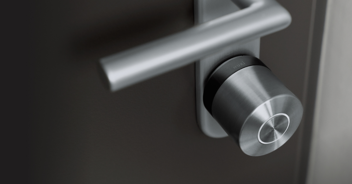 The Smart Lock Ultra with black ring mounted to a black door with silver hardware.